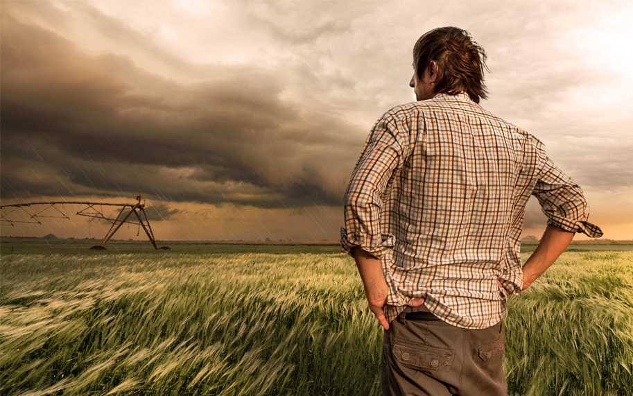 Farmer watching hail storm